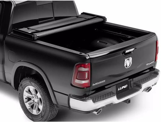 Tri Fold soft tonneau cover for Ram 1500 Laramie by Lund Motion Products Inc, shown folded on the truck bed.