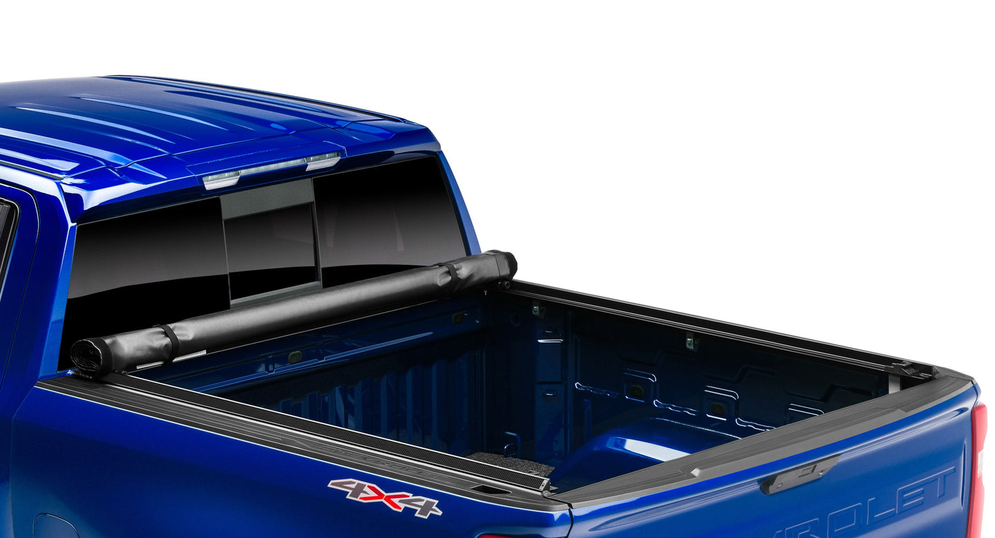 Lund Motion Products Inc Roll Up SOFT Tonneau cover on a Ram 1500 Laramie pickup truck, shown rolled up for easy bed access.