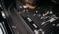 HUSKY LINERS X-ACT AXS for Dodge Ram 3500 Crew Cab, durable all-weather floor liners with textured surface and raised edges.
